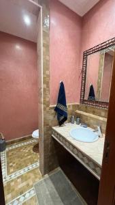 a bathroom with a sink and a toilet and a mirror at Les Jardins de la Palmeraie 3 in Marrakesh