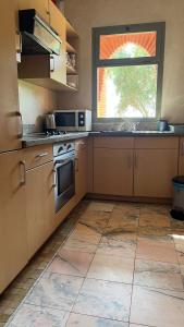 a kitchen with a stove and a window in it at Les Jardins de la Palmeraie 3 in Marrakesh