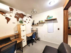 an office with a desk and a world map on the wall at Home La Reina in Guadalajara