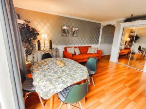 a living room with a table and a couch at Gilford Beachfront Stay, Pool, WiFi & Parking Incl in Laconia