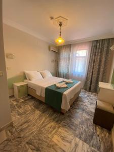 a hotel room with a bed and a window at ÖZ-AY APART OTEL in Marmaris +25 photos