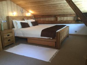 a bedroom with a large bed in a wooden cabin at La Grange De L'Aiguille in Chamonix