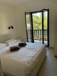 a bedroom with a large bed and a balcony at Star Hill Apartments in Nova Varoš +84 photos