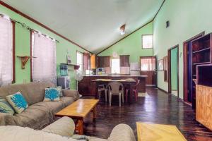 a living room with a couch and a table at Casa Jessita in Caye Caulker