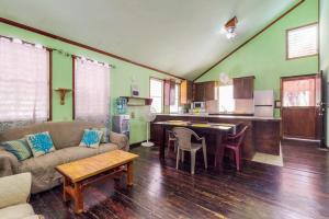 a living room with a couch and a table at Casa Jessita in Caye Caulker +20 photos