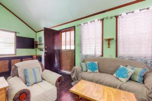 a living room with a couch and a table at Casa Jessita in Caye Caulker