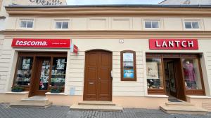 a store front of a building with three windows at Apartmán Štúr Trenčín Centrum in Trenčín