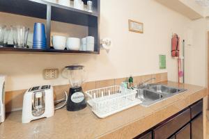 a kitchen counter with a sink and a blender at Family Getaway Suite at Hummingbird Home Suites Gold Standard Certified in San Pedro