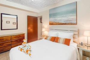 a bedroom with a large white bed and a desk at Family Getaway Suite at Hummingbird Home Suites Gold Standard Certified in San Pedro