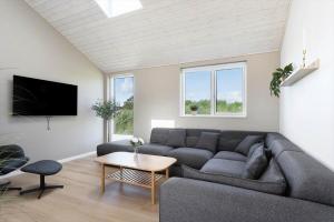 a living room with a couch and a table at TV1737-Bindslev-Mellemklitvej-23 in Tversted