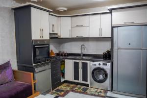 a kitchen with white cabinets and a washing machine at dakhla home in Aït Krad +63 photos