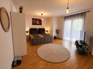 a living room with a couch and a rug at Modern Comfort Apartment with Balcony in Dresden