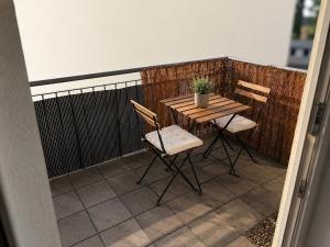 a wooden table and chairs on a balcony at Modern Comfort Apartment with Balcony in Dresden