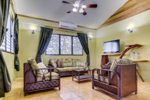 a living room with a couch and a tv at Suite at Villa Maya -Gold Standard and Certified in San Ignacio
