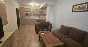 a living room with a couch and a table at Sun Sea App in Shkorpilovtsi