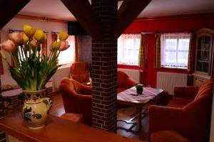 a living room with a vase of flowers on a table at Farma Wenet in Broumov