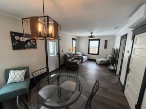 a living room with a glass table and chairs at Esplanade at Clear Lake in Waseca
