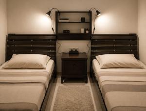 a bedroom with two beds and a nightstand between them at Sliema central apartment in Sliema
