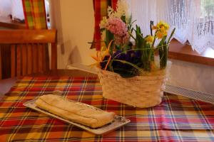 a basket of flowers and a slice of bread on a table at Farma Wenet in Broumov +83 photos