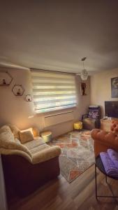 a living room with a couch and a window at Sunny Funny House in Čačak