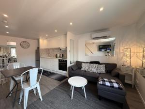 a living room and kitchen with a couch and a table at *Climatisé* Duplex en hyper centre refait à neuf in Le Puy-en-Velay +7 photos