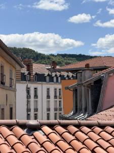 a view of the roofs of a city with buildings at *Climatisé* Duplex en hyper centre refait à neuf in Le Puy-en-Velay