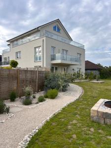 a large white house with a fence and a yard at Ferienhaus Lounis in Bützow