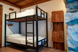 a bedroom with two bunk beds in a room at Beds Hostel in Gjirokastër