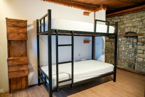 a bunk bed room with two bunk beds at Beds Hostel in Gjirokastër +34 photos