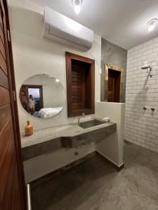 a bathroom with a sink and a mirror at Casa da dunas in Prea +16 photos