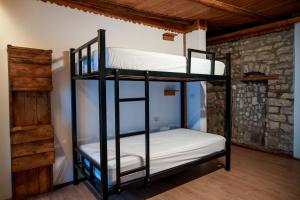 a bunk bed room with two bunk beds at Beds Hostel in Gjirokastër