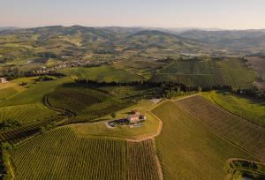 an aerial view of a farm with mountains in the background at Podere Mantignano 2 in Faenza