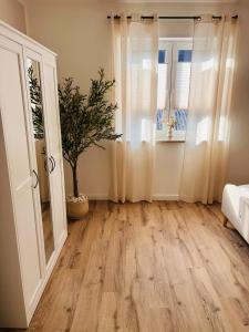 a living room with a hardwood floor and a window at Ferienhaus Lounis in Bützow +36 photos