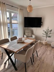 a dining room with a wooden table and chairs at Ferienhaus Lounis in Bützow