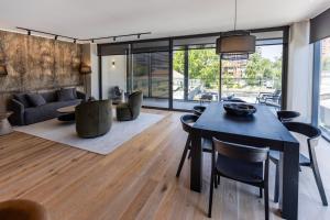a living room with a table and chairs and a couch at At Home Alonso in Santiago