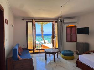 a bedroom with a room with a view of the ocean at Leonessa's Villa in Dahab