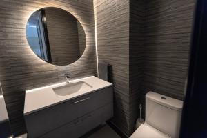 a bathroom with a sink and a mirror at At Home Alonso in Santiago