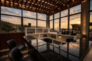 a room with large windows with a view of the city at Hotel Boutique Piedra & Altura in San Juan Teotihuacán
