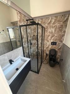 a bathroom with a shower and a tub and a sink at Il campanile in Corbetta +13 photos
