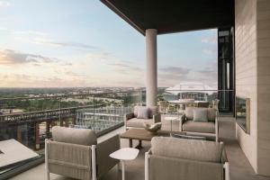 a balcony with chairs and tables and a view at Loews Arlington Hotel in Arlington +285 photos