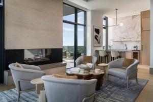 a living room with chairs and a fireplace at Loews Arlington Hotel in Arlington