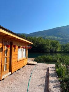 a log cabin with a view of a lake at Pliva Escape in Jezero