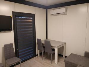 a dining room with a table and chairs and a door at Domki u Krukow in Łuka