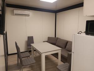 a living room with a table and a couch at Domki u Krukow in Łuka