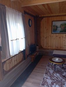 a room with a window and a table in a room at Četiri sestre in Žabljak