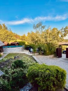 a garden with a table and chairs and trees at Cozy Green Escape in Kakanj