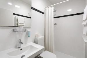 a bathroom with a sink and a toilet and a mirror at HOTEL ATLANTA Darmstadt SUPERIOR in Darmstadt