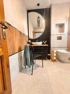 a bathroom with a sink and a toilet and a mirror at Apartamenty Art Komfort in Czersk Pomorski +154 photos