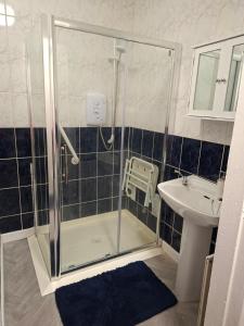 a bathroom with a shower and a sink at Judys View in Cashel +8 photos