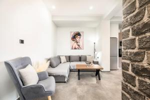 a living room with a couch and a table at Thalori villa 2 in Psalidi